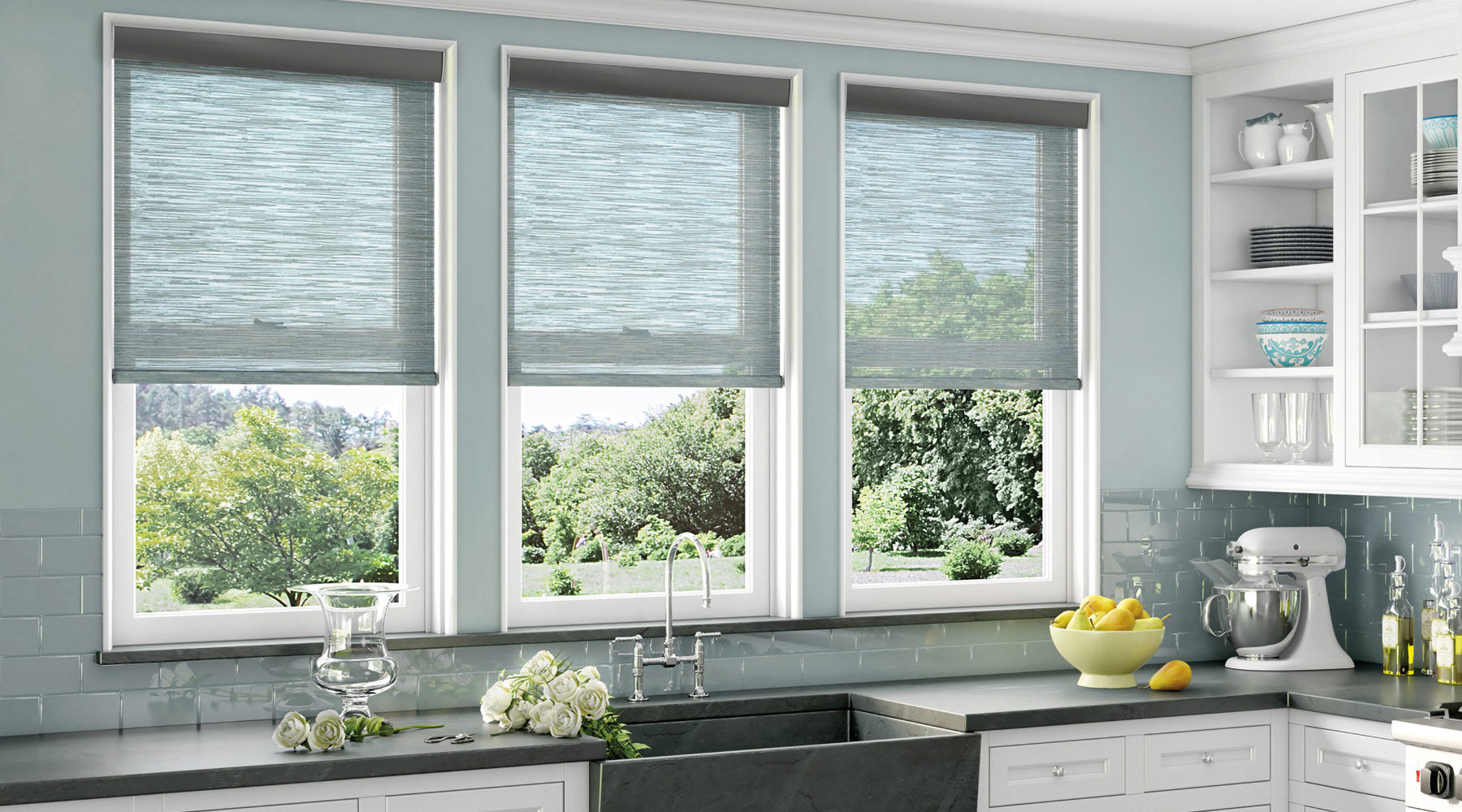 shop custom window treatments at Regal Paint Cetners. Modern kitchen with gray/blue walls, white cabinets, and modern light filter window shades.
