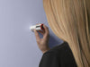 A woman using the Datacolor ColorReaderPRO on a light purple wall to determine the closest paint color match, a professional color reading device available at Regal Paint Centers in MD, VA & the Washington, DC metro.